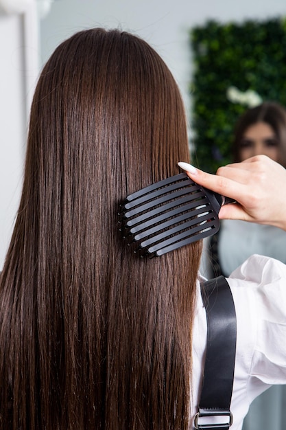 A straight healthy brunette hair that has undergone the hair straightening procedure