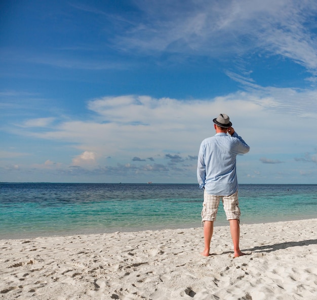 Strand vakantie. Man en tropisch strand op de Malediven.