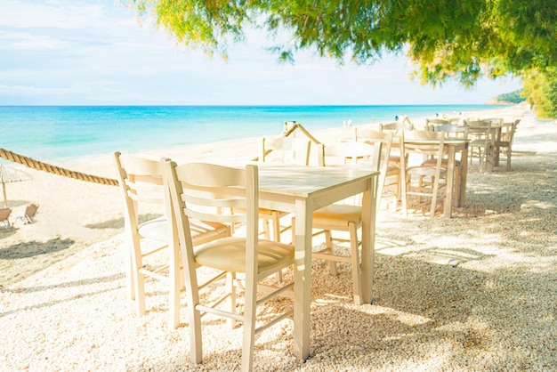 Strandrestaurant met alle witgekleurde meubels voor de turquoise kleuren van de zee