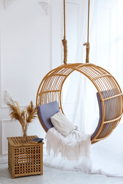 Straw hanging swing in a bright room by the window