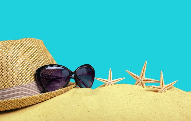 straw hat on beach sand