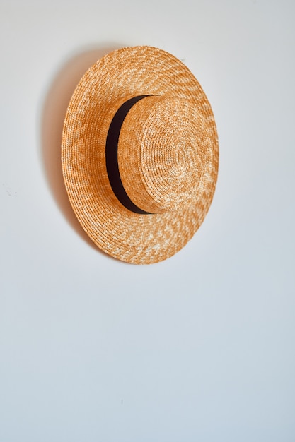 Straw hat hanging on hook.