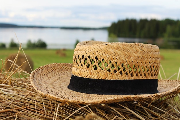 Straw hat on a haystack in a field closeup summer mood