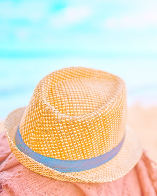 Straw hat on a hot day off. Teal and orange toned.