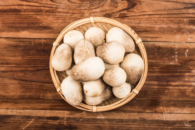 Straw mushroom group on wooden background