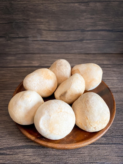 Straw mushroom in the wooden plate on the table