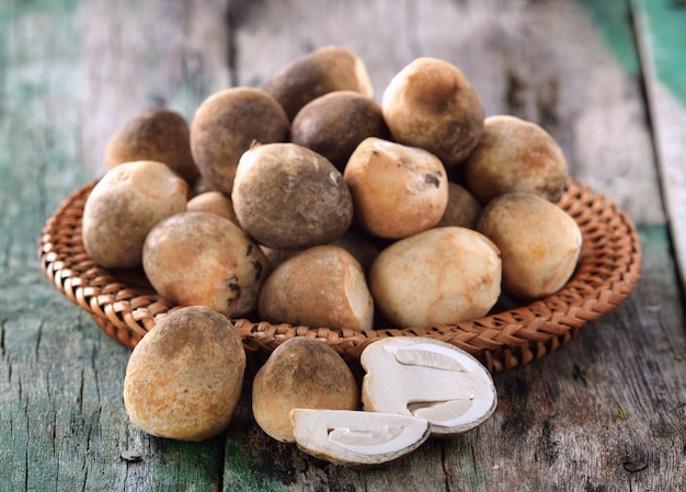 Straw mushrooms on wooden