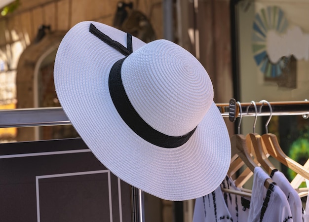 Straw women's hat with black ribbon closeup