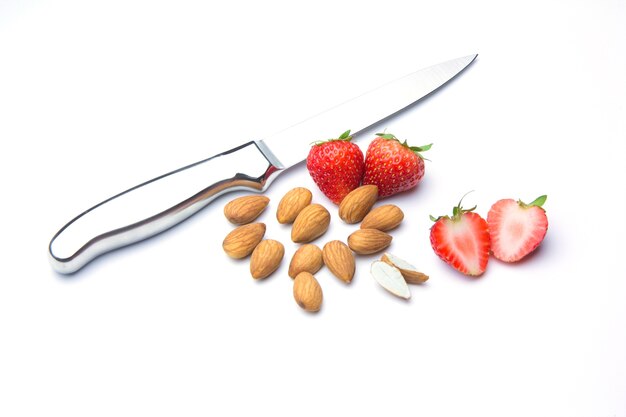 Strawberries and almonds isolated .