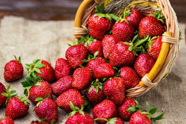 Strawberries in basket on wooden table