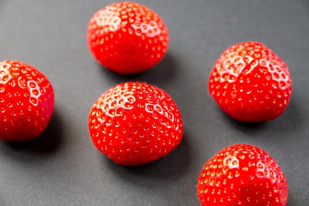 Strawberries on black table. Studio shooting