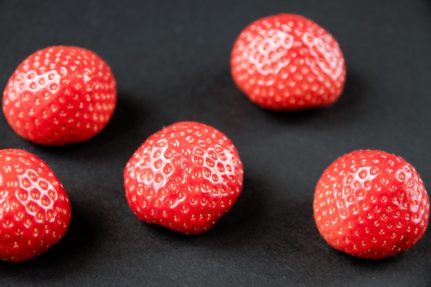 Strawberries on black table. Studio shooting