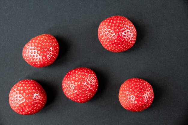 Strawberries on black table. Studio shooting