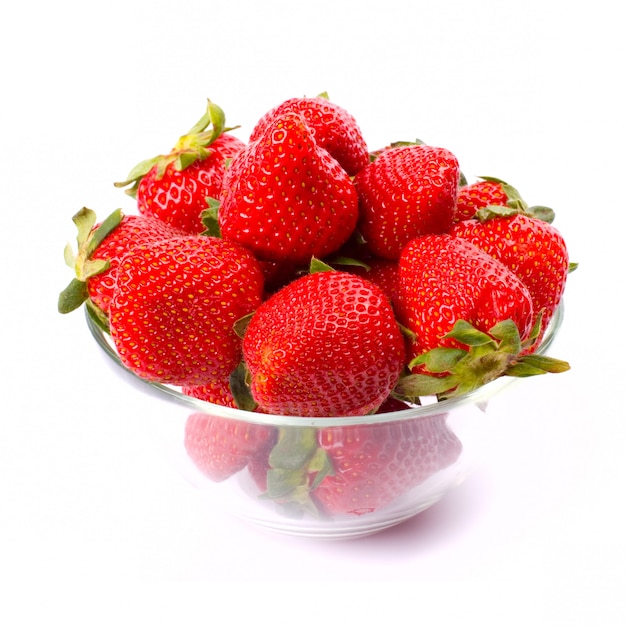 Strawberries in the bowl closeup on white background