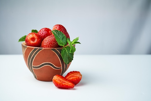 Premium Photo | Strawberries in a ceramic bowl on a light background
