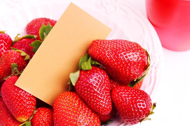 Strawberries in a ceramic bowl with a gift card for an inscription