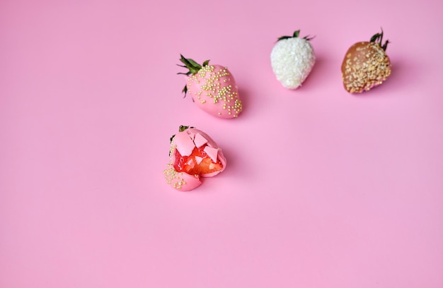 Strawberries in chocolate on a pink background Sweet snack with berries in chocolate