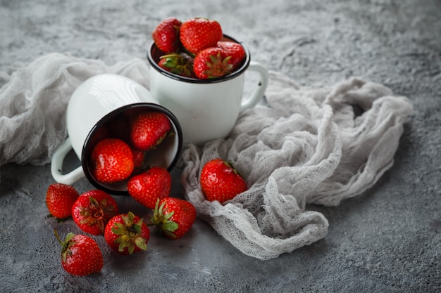 Strawberries in enamel mugs