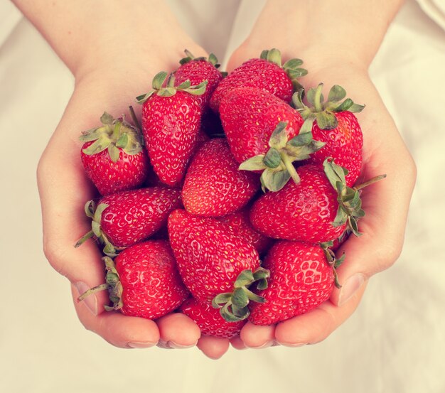 Strawberries in female hands