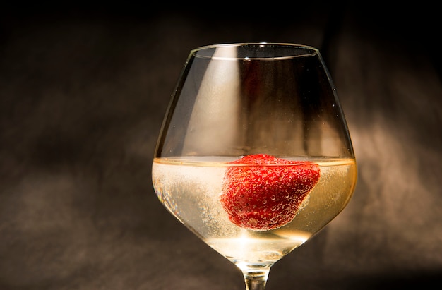 Strawberries inside the white wine glass