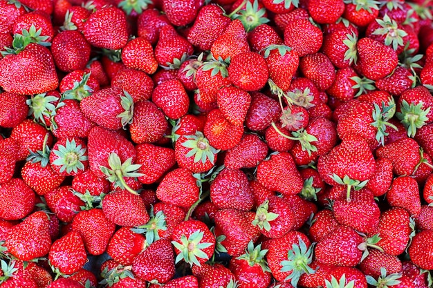 Strawberries on the market counter, fresh summer berries.