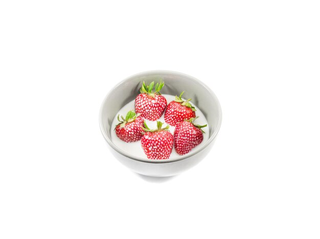 Strawberries in milk cream on a white background