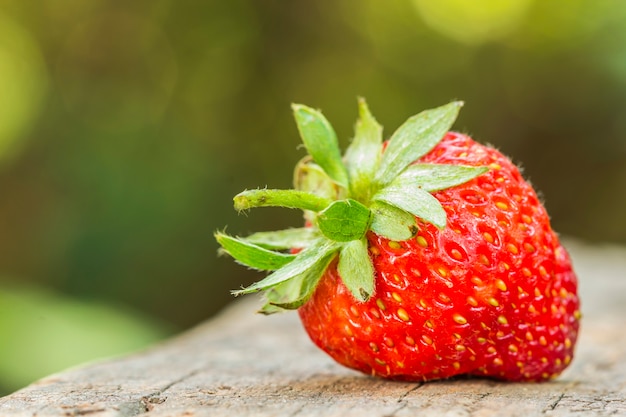 Strawberries on old wooden textured table 