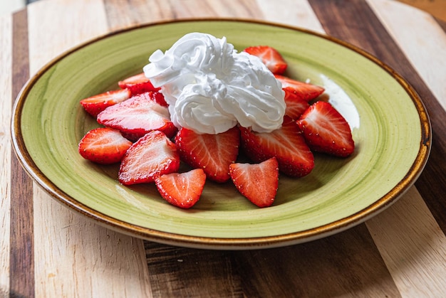 Strawberries on a plate with cream Yummy