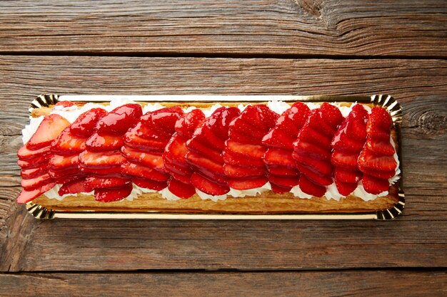 Strawberries puff pastry pie on wood