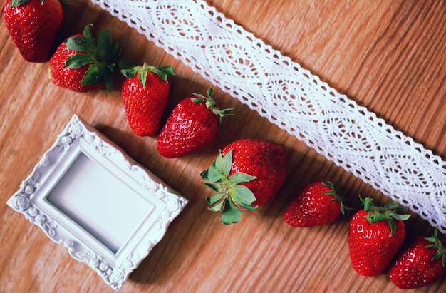 Strawberries top on wooden and lace