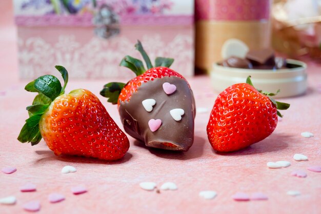 Strawberries with chocolate and without chocolate with other background objects