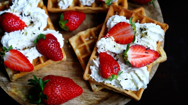 Strawberries with cream on Viennese waffles Summer dessert with strawberries