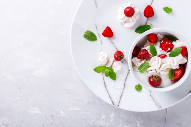 Strawberries with whipped cream and meringue