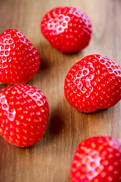 Strawberries on a wooden cutting board. closeup view