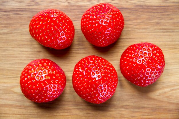 Strawberries on a wooden cutting board. Closeup view