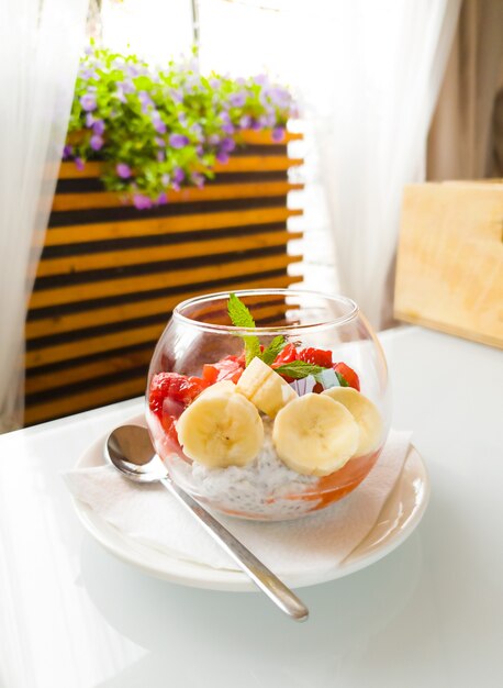 Strawberry and banana and chia dessert in the cup in restaurant.