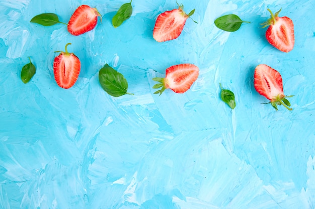 Strawberry and basil on blue