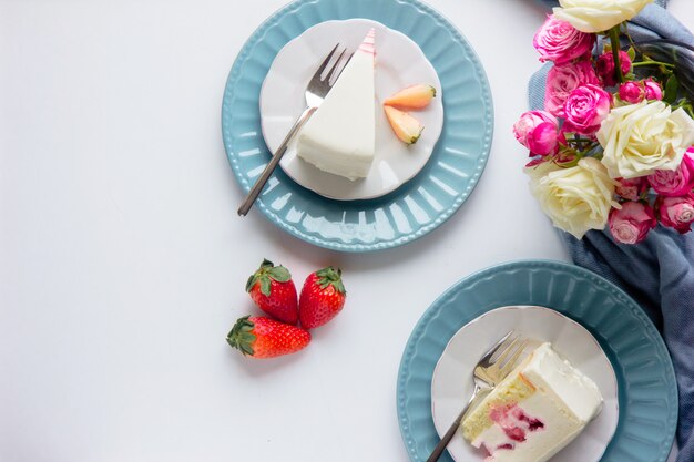 Strawberry cake, spring roses flowers. Beautiful breakfast