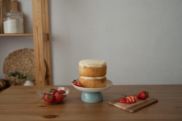 Strawberry cake on stand on wooden table