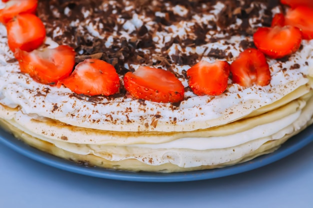 Strawberry cake with chocolate on ceramics plate