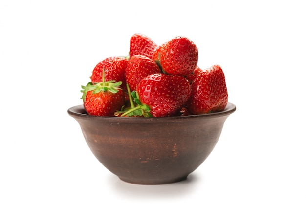 Strawberry in ceramic brown bowl