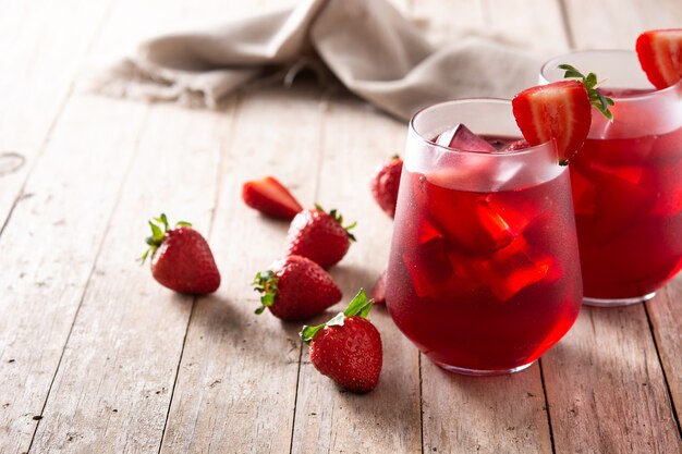 Strawberry cocktail in glass on wooden table