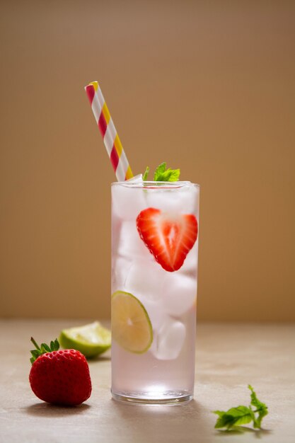 Strawberry cold drink with fresh berry, lime and mint. Summer cold drink with papper straw