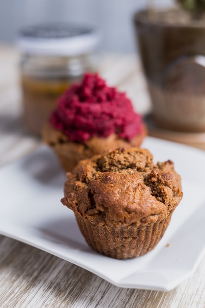 Strawberry cupcake on a wooden table