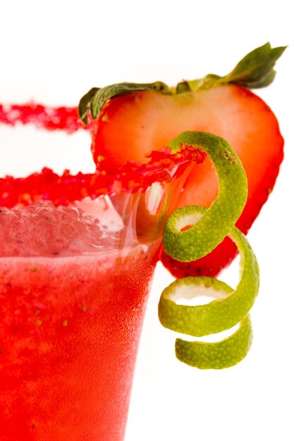 Strawberry daiquiri cocktail with strawberry and lime as a garnish.