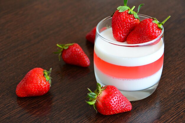 strawberry dessert in glass with fresh berries, close-up