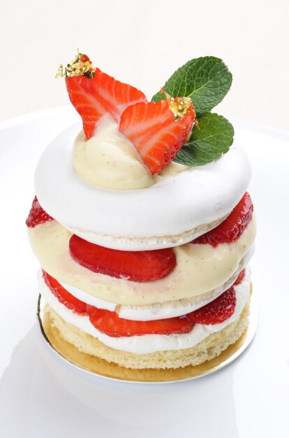 Strawberry dessert with meringue on a white background