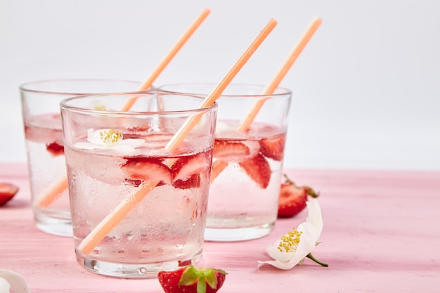 Strawberry detox water with jasmine flower. Summer iced drink