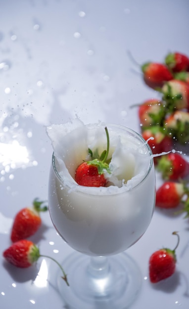 The strawberry drop in to a glass of milk