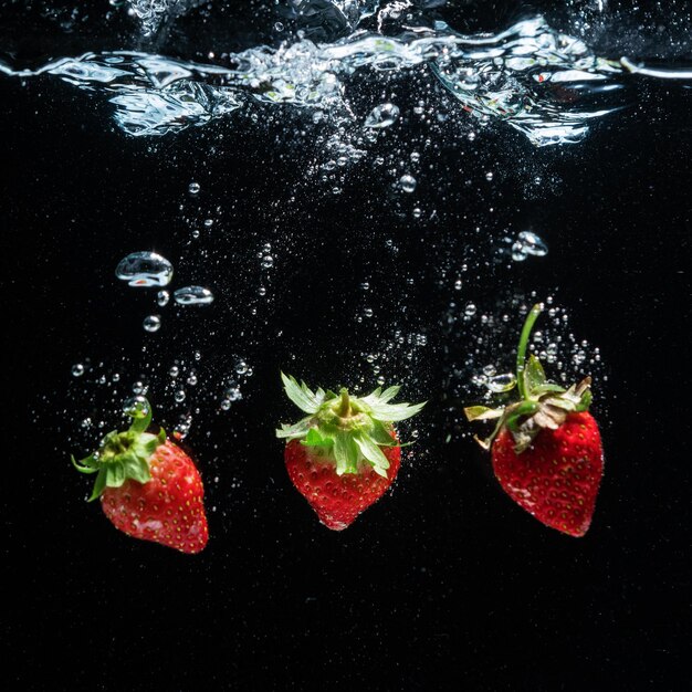 The strawberry falls into of water